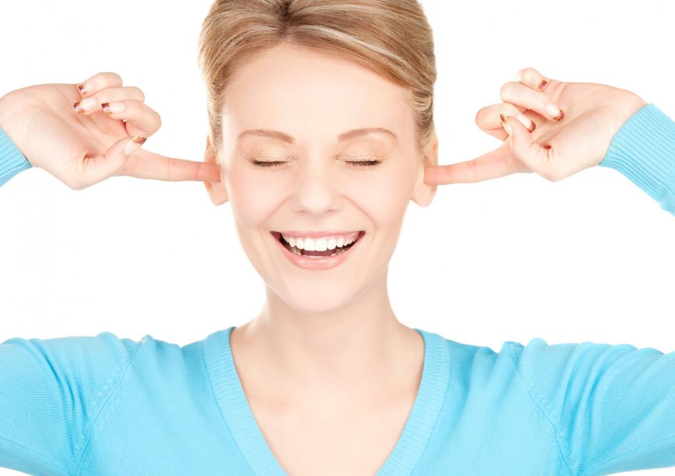 smiling-woman-with-hands-over-ears